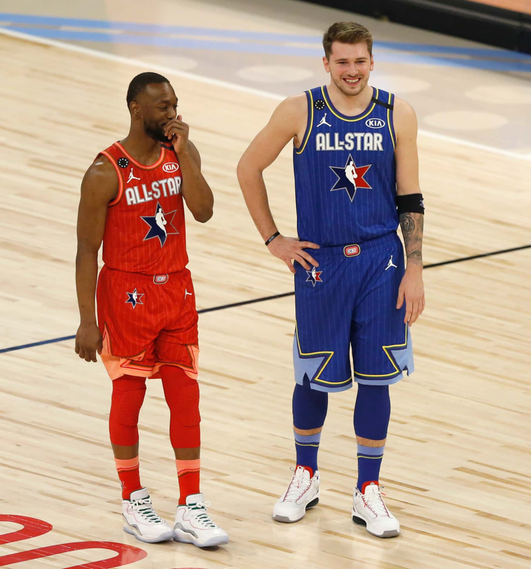 Team LeBron's Luka Doncic (2) and Team Giannis' Kemba Walker (24) share a laugh during a...