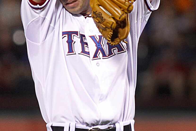 Texas Rangers starting pitcher Nick Tepesch (49) wipes the sweat from his brow before...