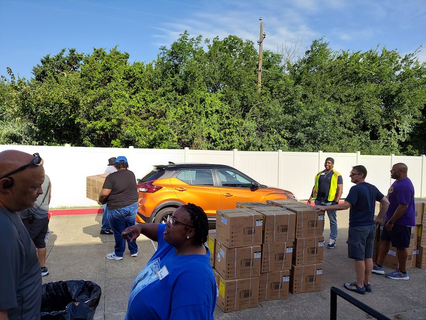 Staff and volunteers from The Senior Source and Community Missionary Baptist Church load...