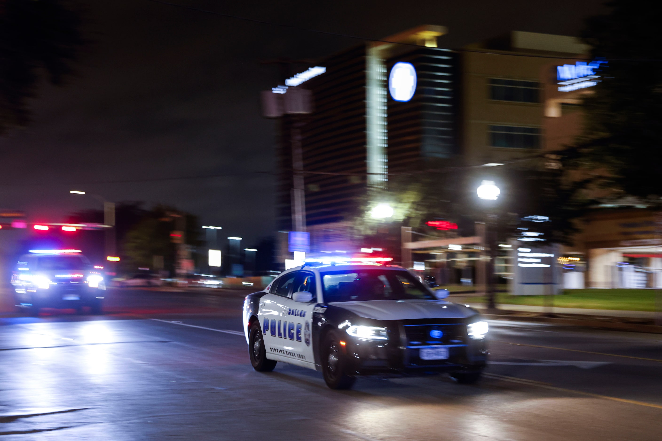 Dallas Police Department officers carry a procession along Colorado Blvd. towards Dallas...