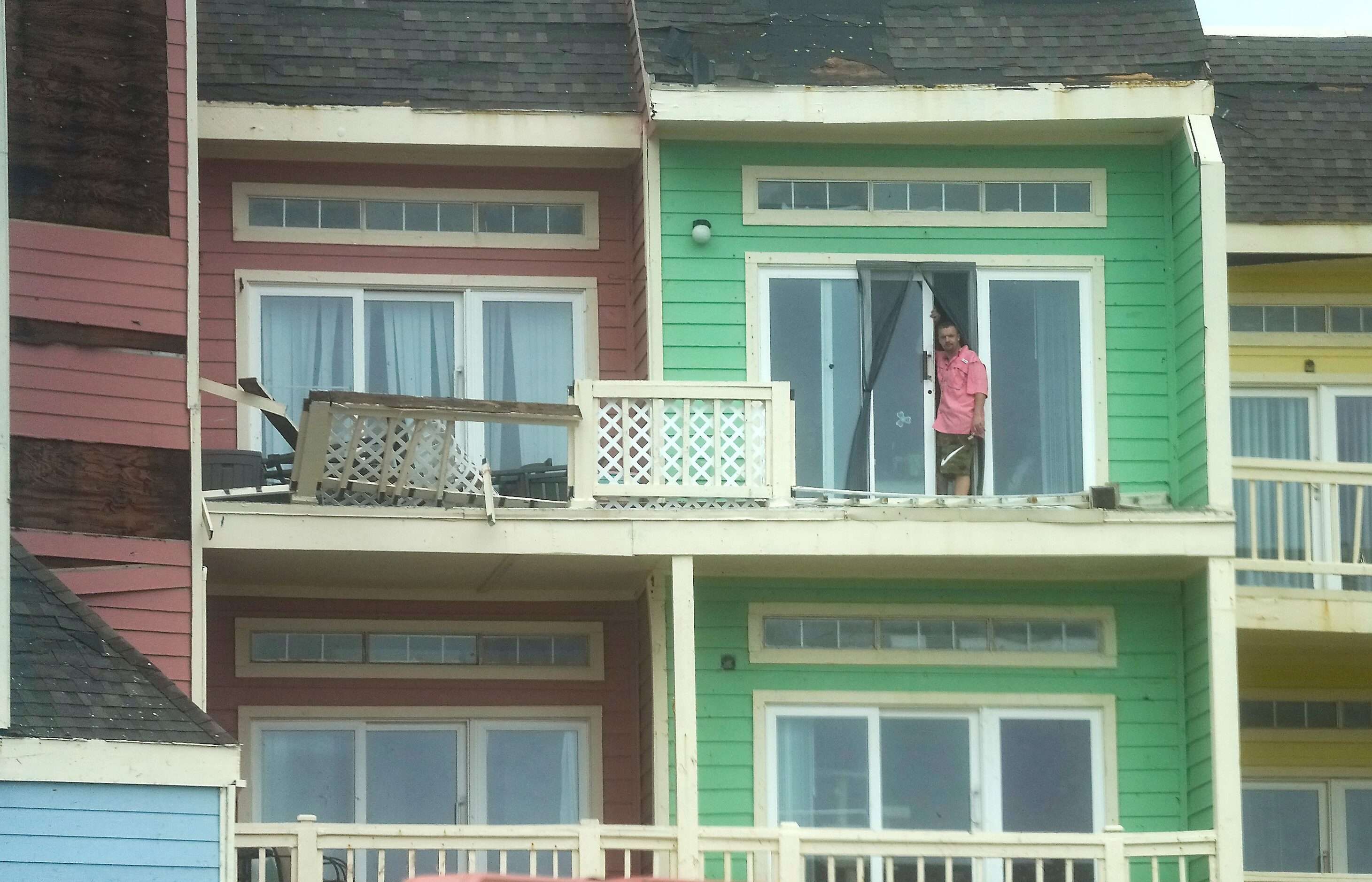 A man looks out a patio at The Oceanfront Loft Apartments in Galveston, Texas, after the...