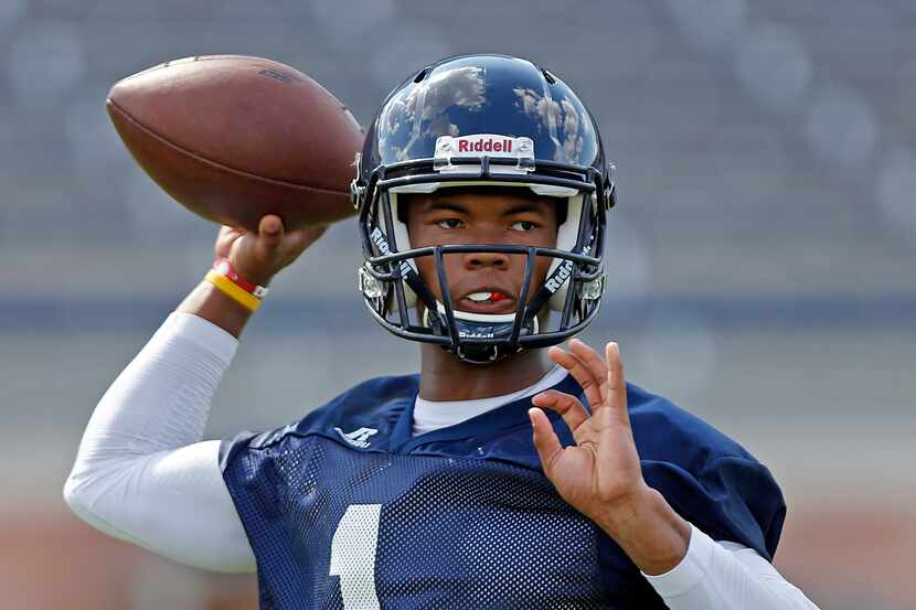 Allen High School quarterback (1) Kyler Murray delivers a pass during a drill in practice at...