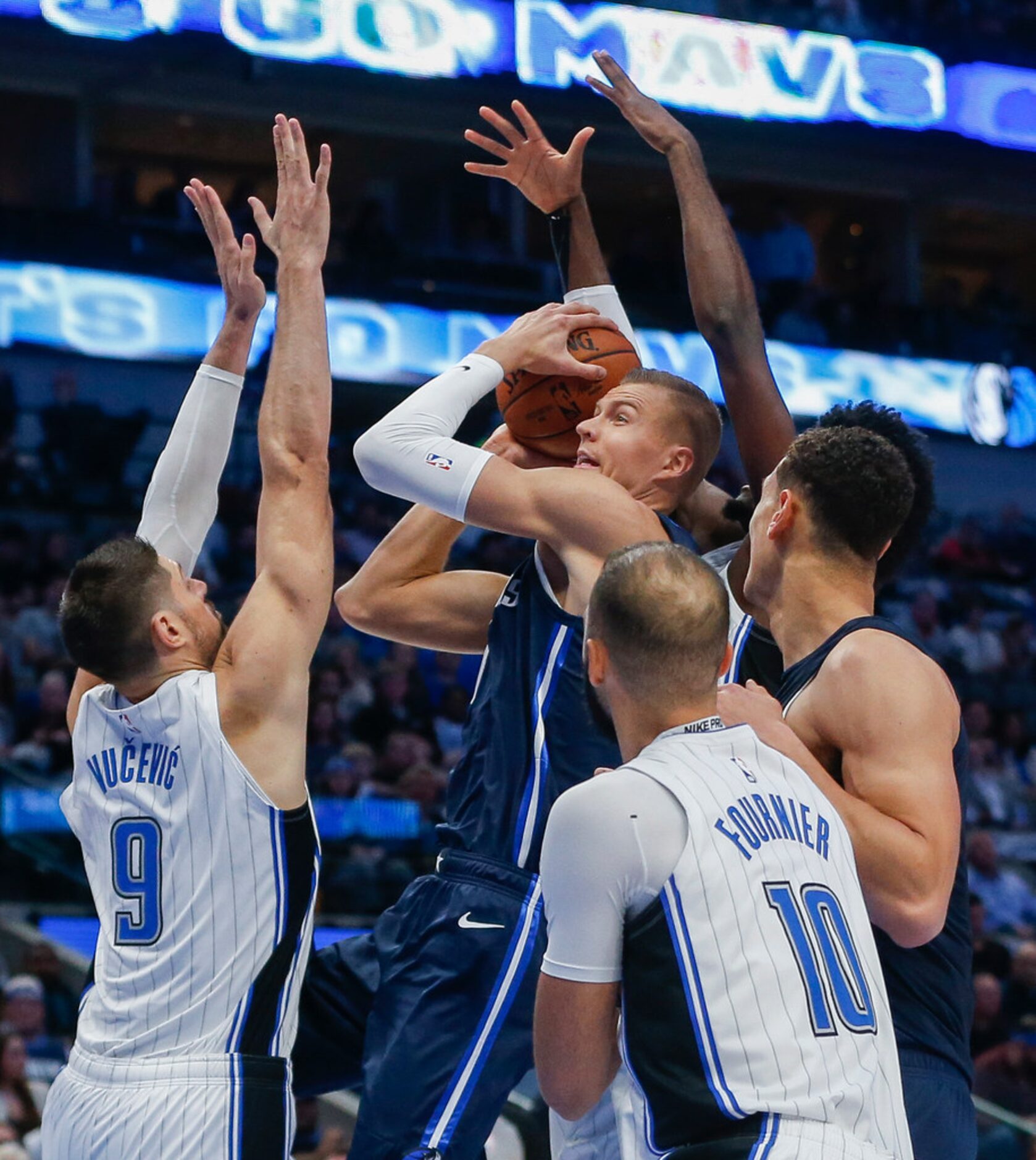 Dallas Mavericks forward Kristaps Porzingis (6) attempts to get a shot past Orlando Magic...