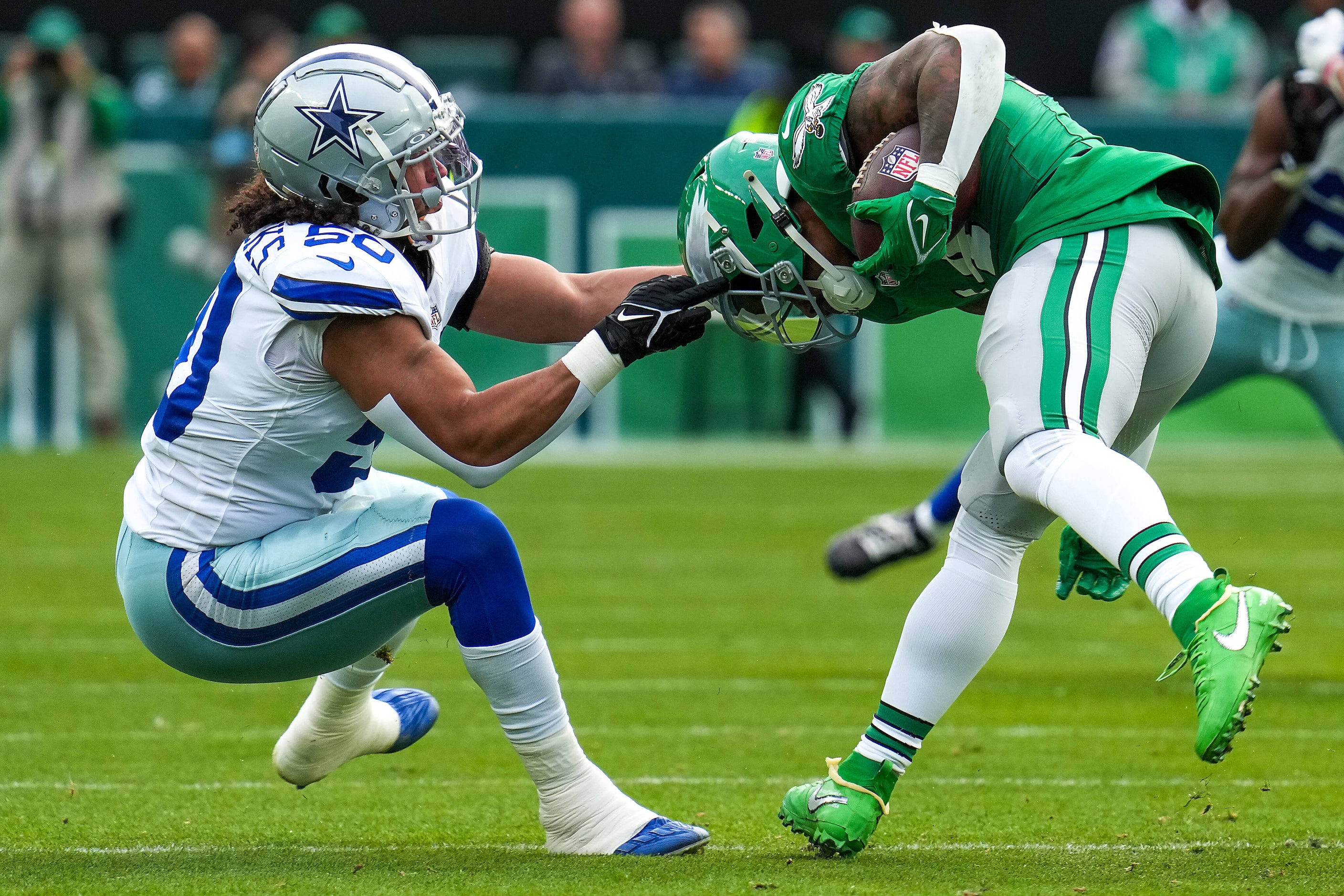 Philadelphia Eagles running back Kenneth Gainwell (14) is brought down by Dallas Cowboys...