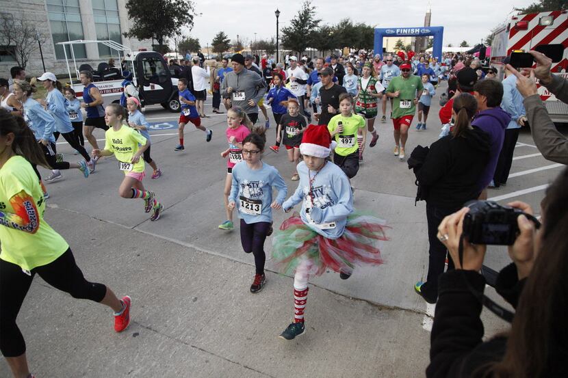 Runners compete in the 5K race during the Frosty 5K and Merry Mile in Frisco on Dec. 13,...