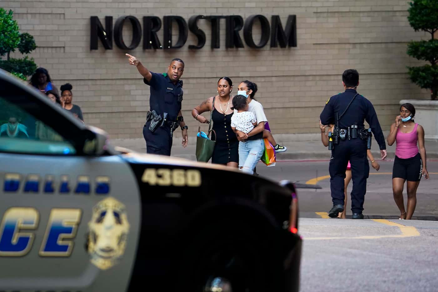Dallas police direct people away from the Nordstrom store at the Galleria Dallas on Tuesday,...