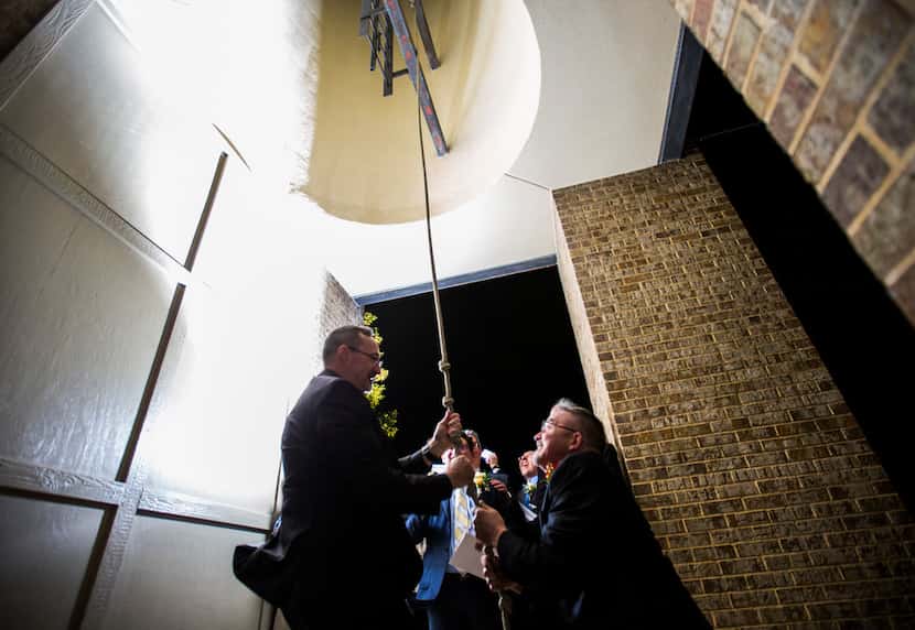 Joel Martinson (left) and David Reece ring church bells after a mass celebration and...