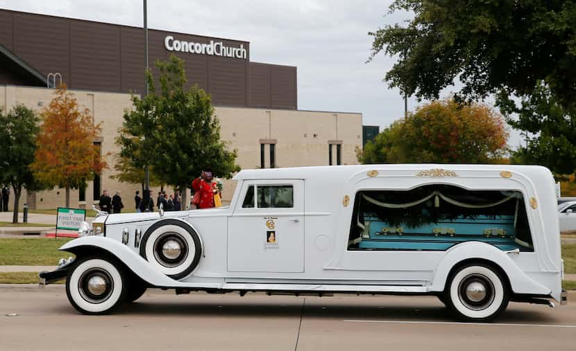 People watch as the hearse pulls out of Concord Church after Atatiana Jefferson's funeral in...