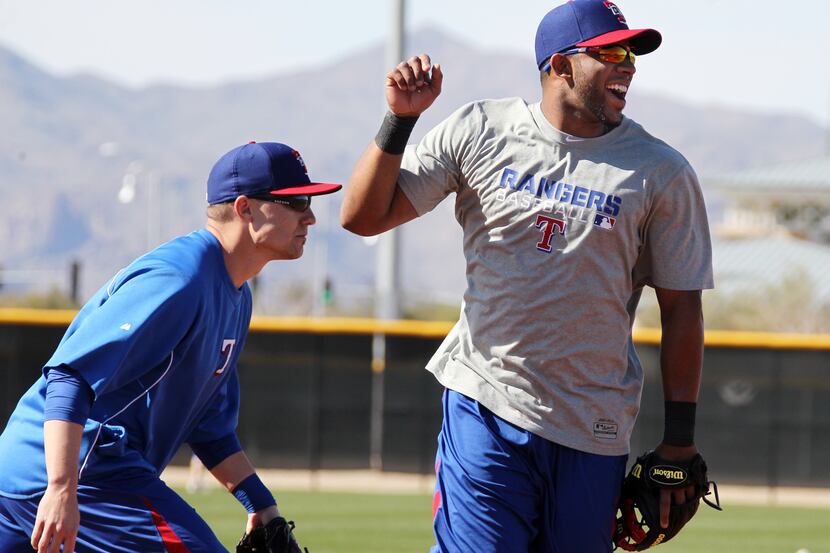 Texas shortstop Elvis Andrus  cheers after shooting a baseball into a bucket like a...