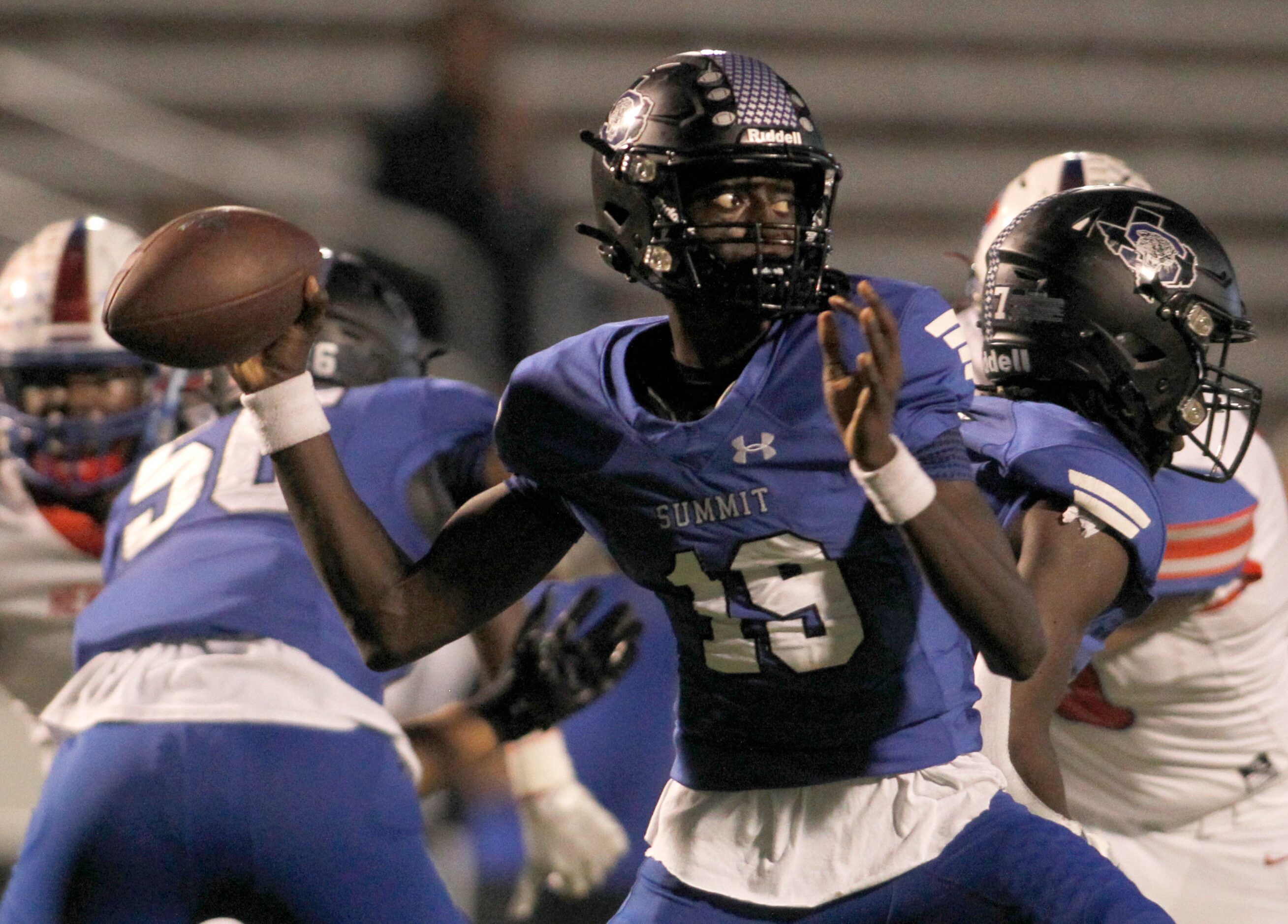 Mansfield Summit quarterback Wayne Tackett (19) looks to pass to a receiver during first...