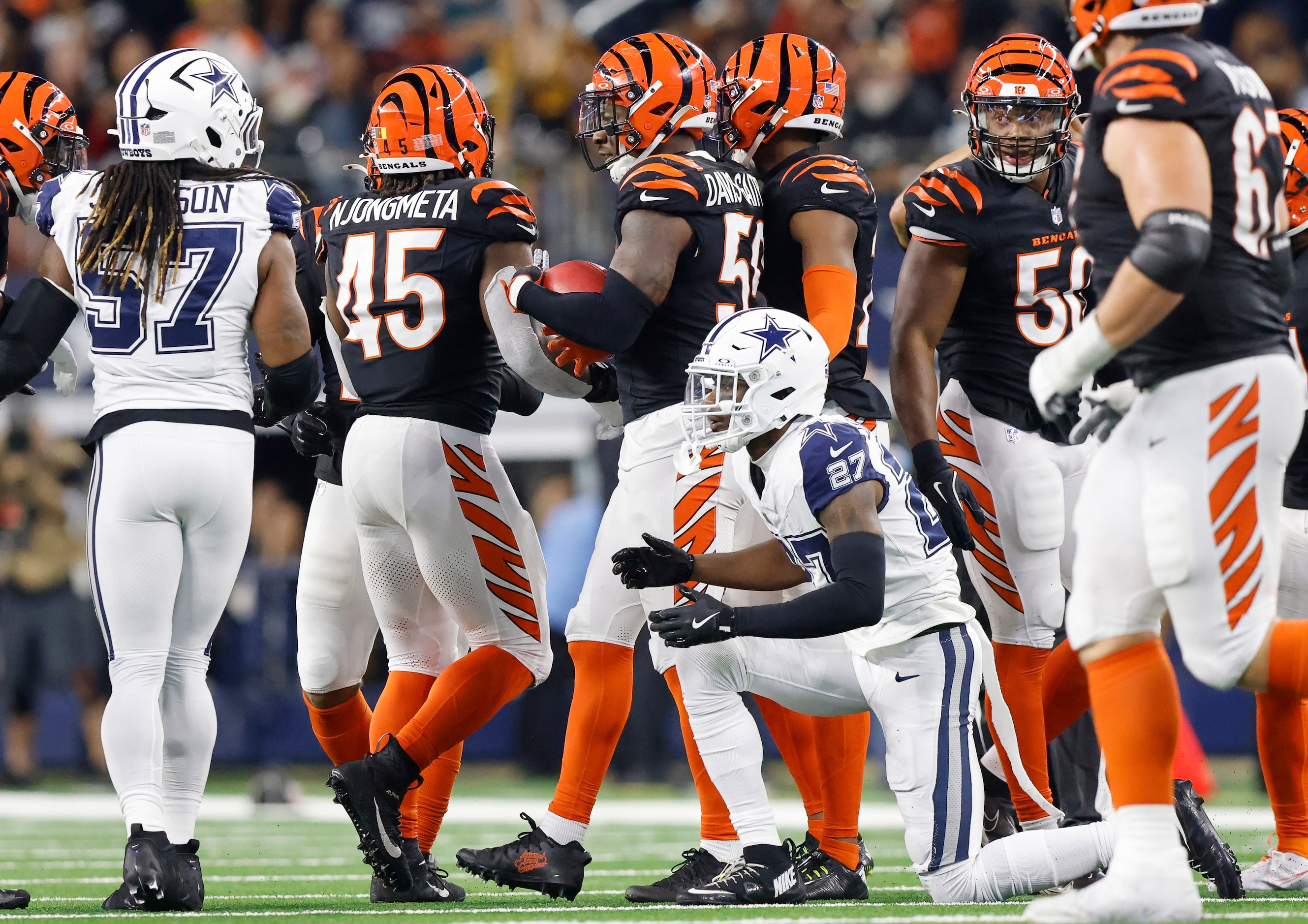 Dallas Cowboys cornerback Amani Oruwariye (27) gets to his feet after muffing a blocked punt...