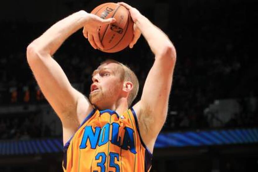 Chris Kaman of the New Orleans Hornets takes a jump shot against the Minnesota Timberwolves...