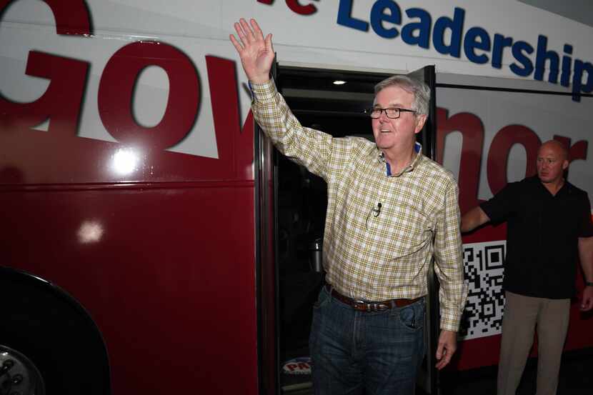 Texas Lt. Gov. Dan Patrick waves at supporters as he walks off his campaign bus at the...