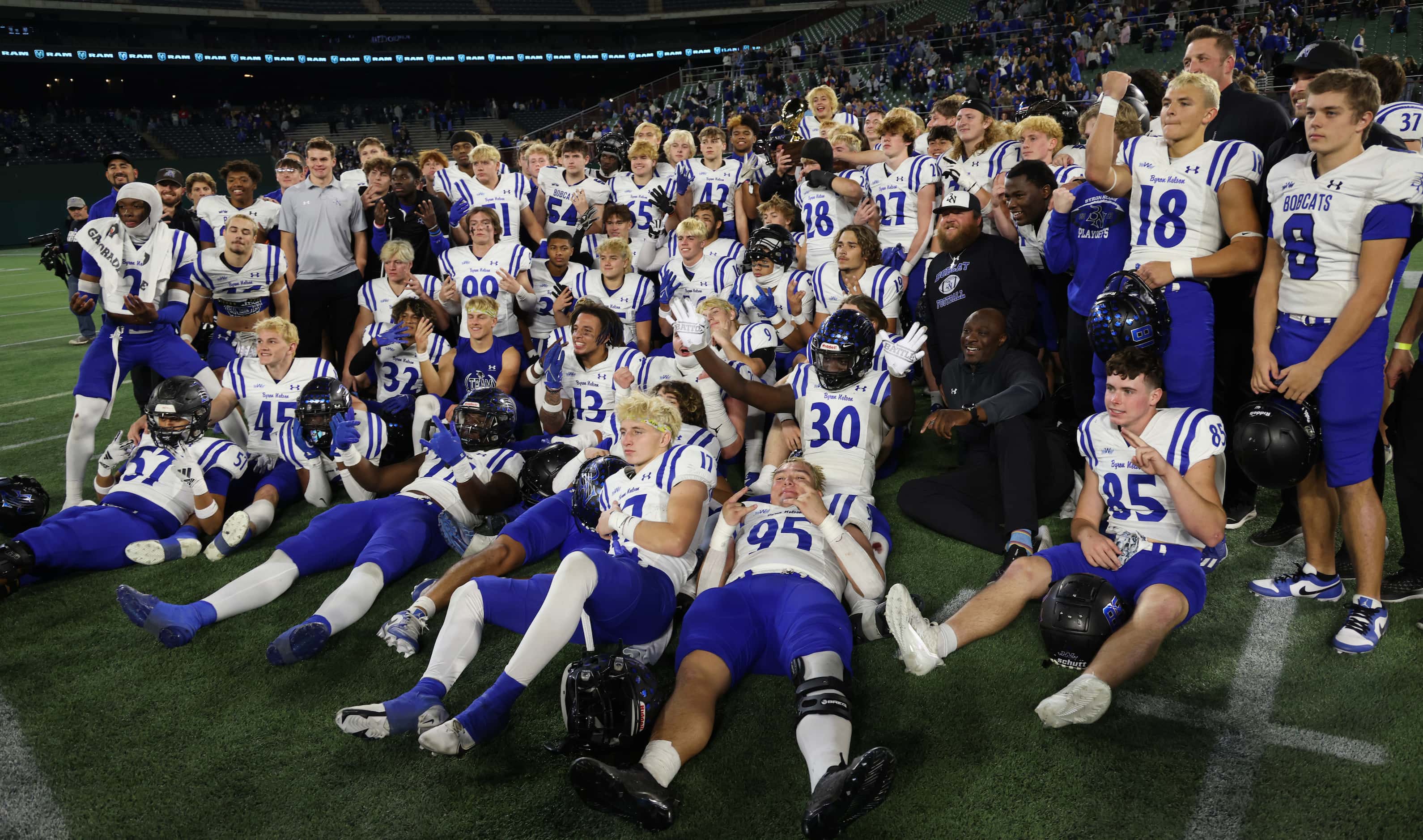 Byron Nelson players and coaches pose for a photo after the team's 52-45 victory over...