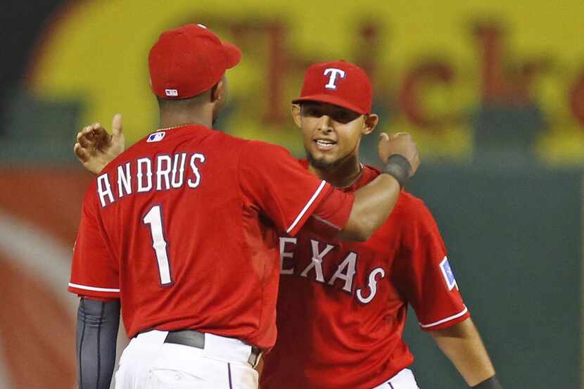 Texas shortstop Elvis Andrus and second baseman Rougned Odor hug after the final out in the...