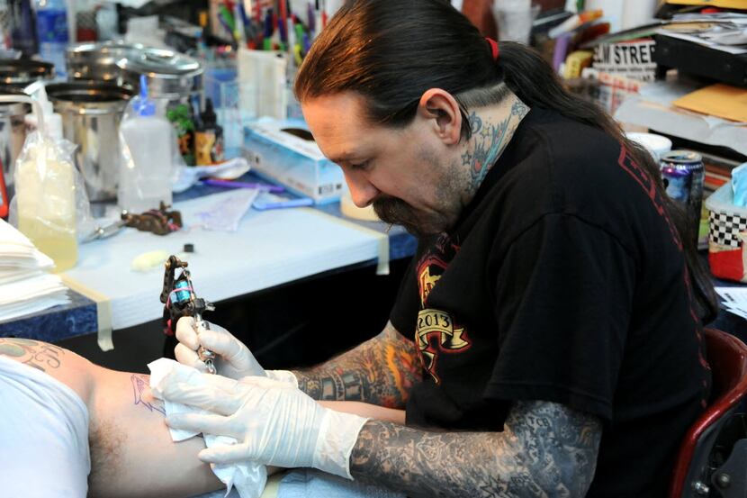 Oliver Peck tattoos Peter Morrissey at Elm Street Tattoo for Friday the 13th in Deep Ellum...