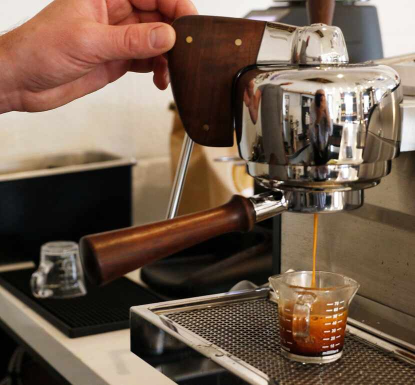 Ben Johnson, co-owner of Local Press + Brew and Local Moto + Provisions, makes an espresso...