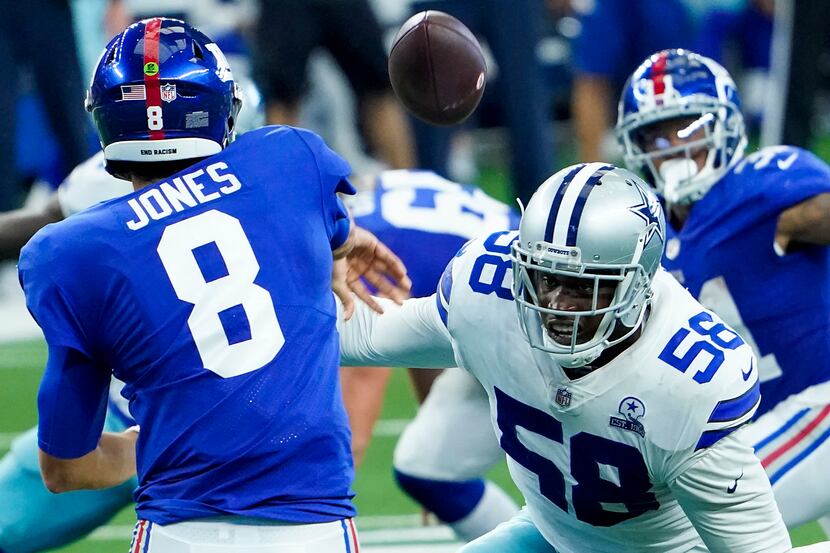 FILE - Giants quarterback Daniel Jones (8) fires a pass while under pressure from Cowboys...