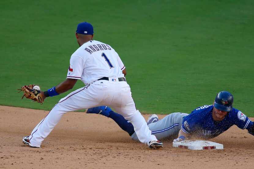 Toronto Blue Jays third baseman Josh Donaldson (20) is safe at second as Texas Rangers...