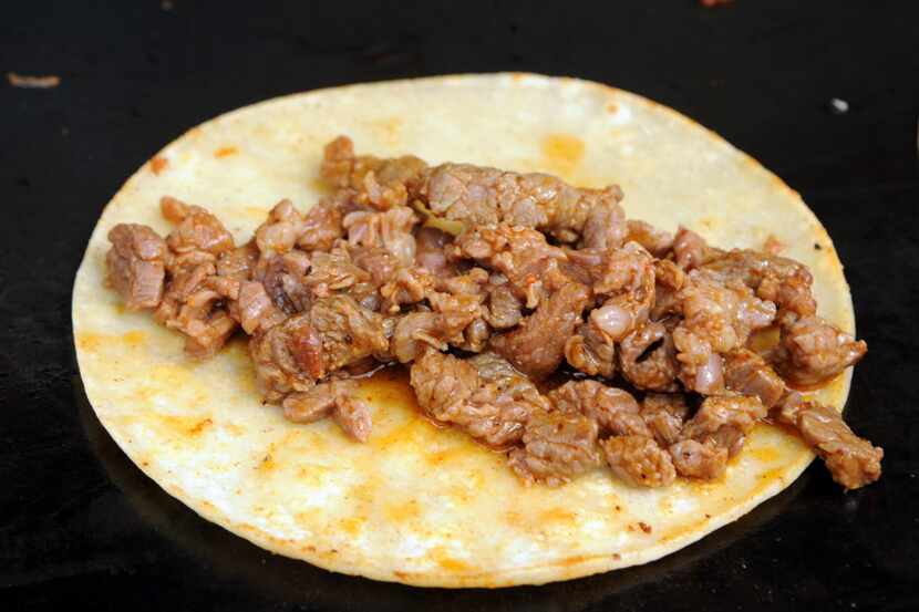 Beef street tacos sizzle on the grill from Gabe's Mexican Grill at Taste of Dallas in Fair...