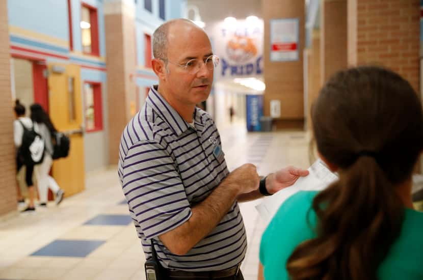 Principal Mitch Curry talks to a student who didn't know which class to go to next at Scott...