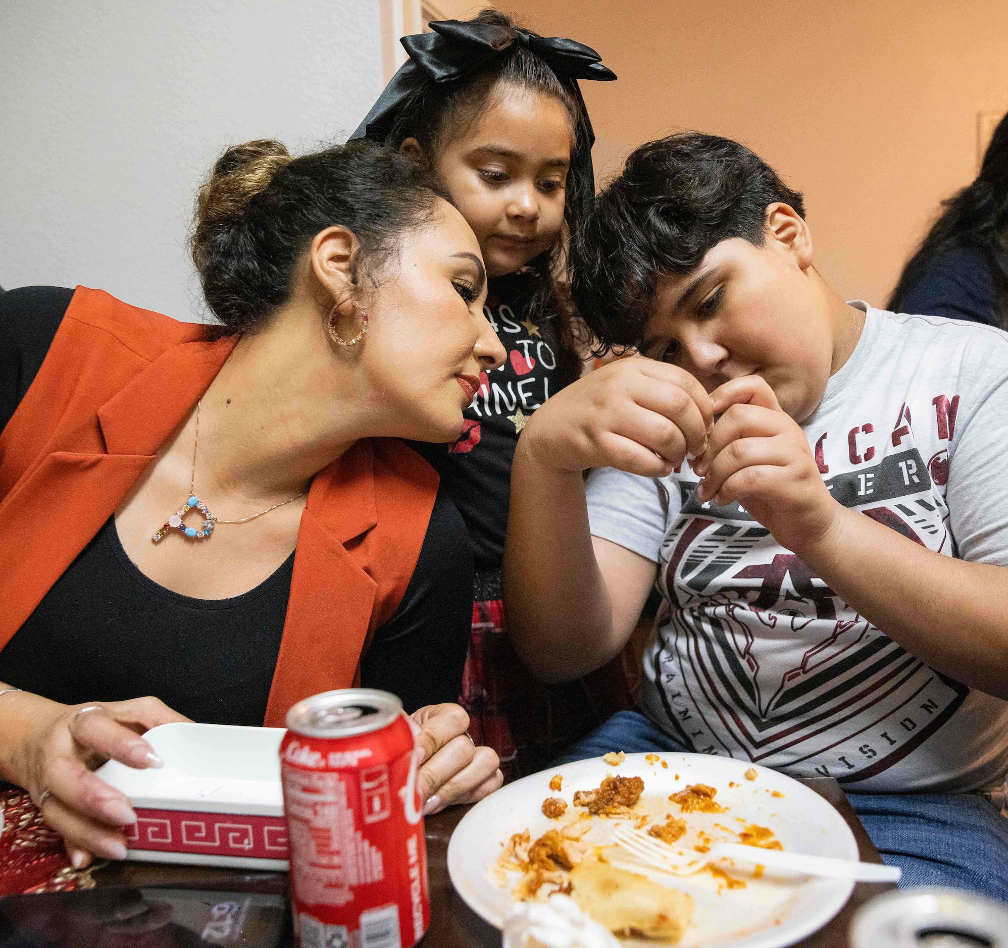 (From left)  Paola Lozoya of Chihuahua and her children Karla Ramos y Víctor Lozoya look to...