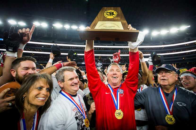 Allen head coach Terry Gambill head coach Terry Gambill hoists the championship trophy after...