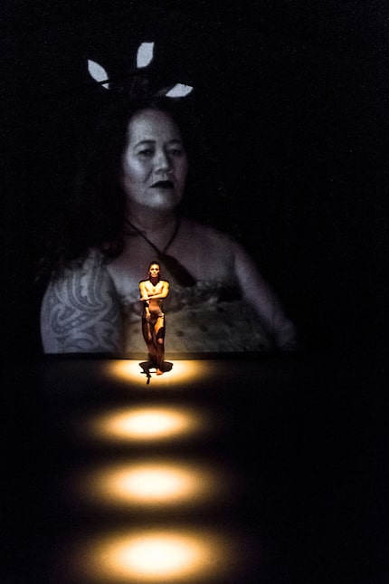 Nancy Wijohn performs in front of a projection of Maori elder Tui Matira Ranapiri-Ransfield...