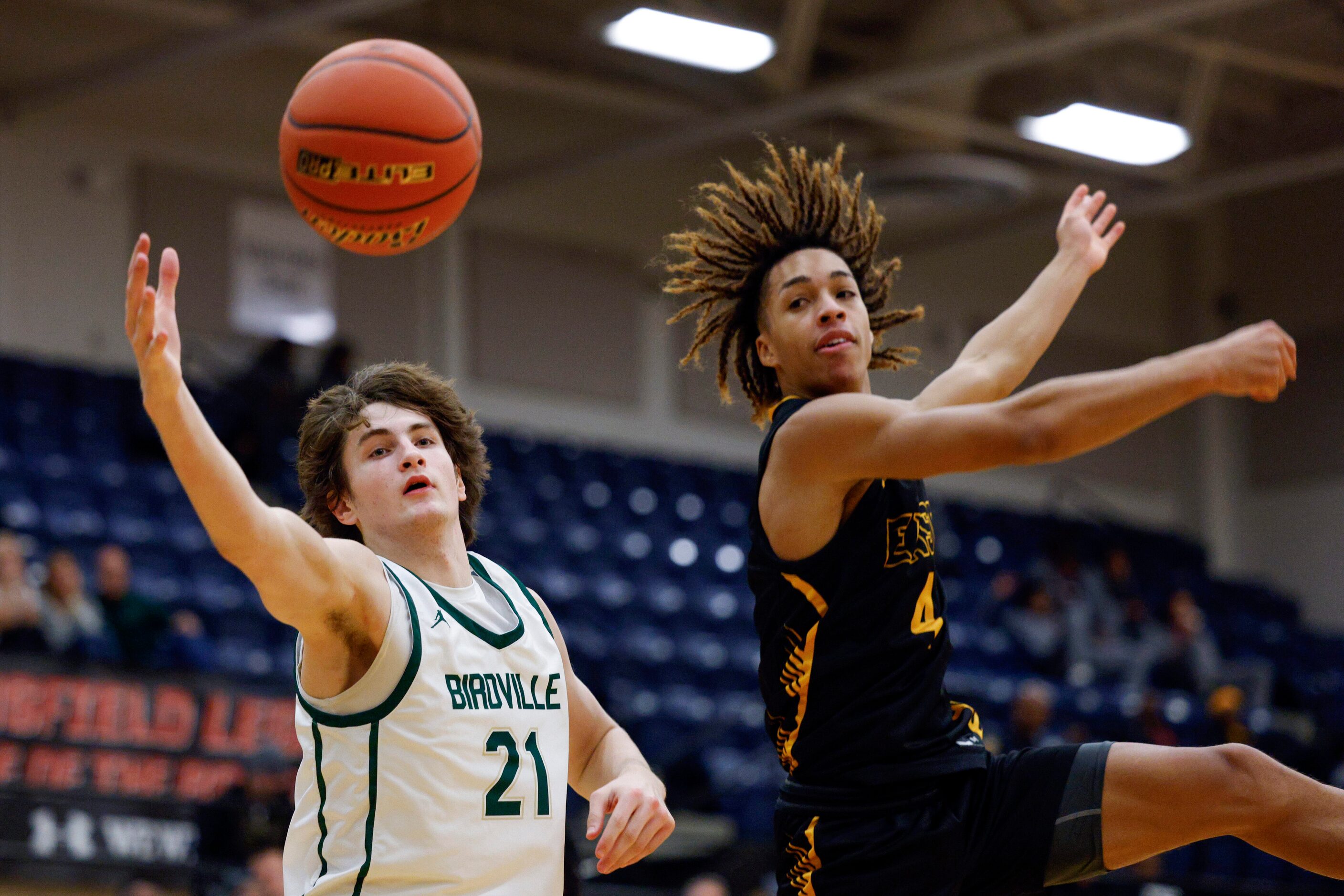 Birdville guard Sawyer Dotson (21) and Plano East guard Jordan Mizell (4) reach for a loose...