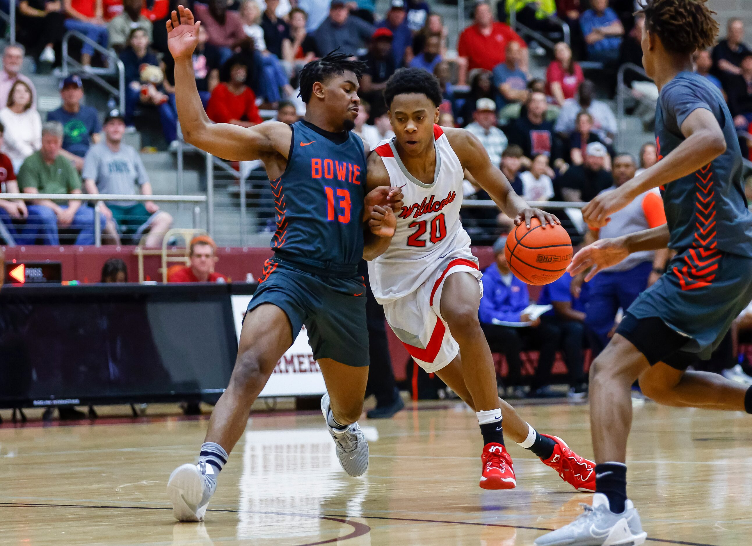 Lake Highlands junior guard Tre Johnson (20) battles Arlington Bowie senior guard Kelby...