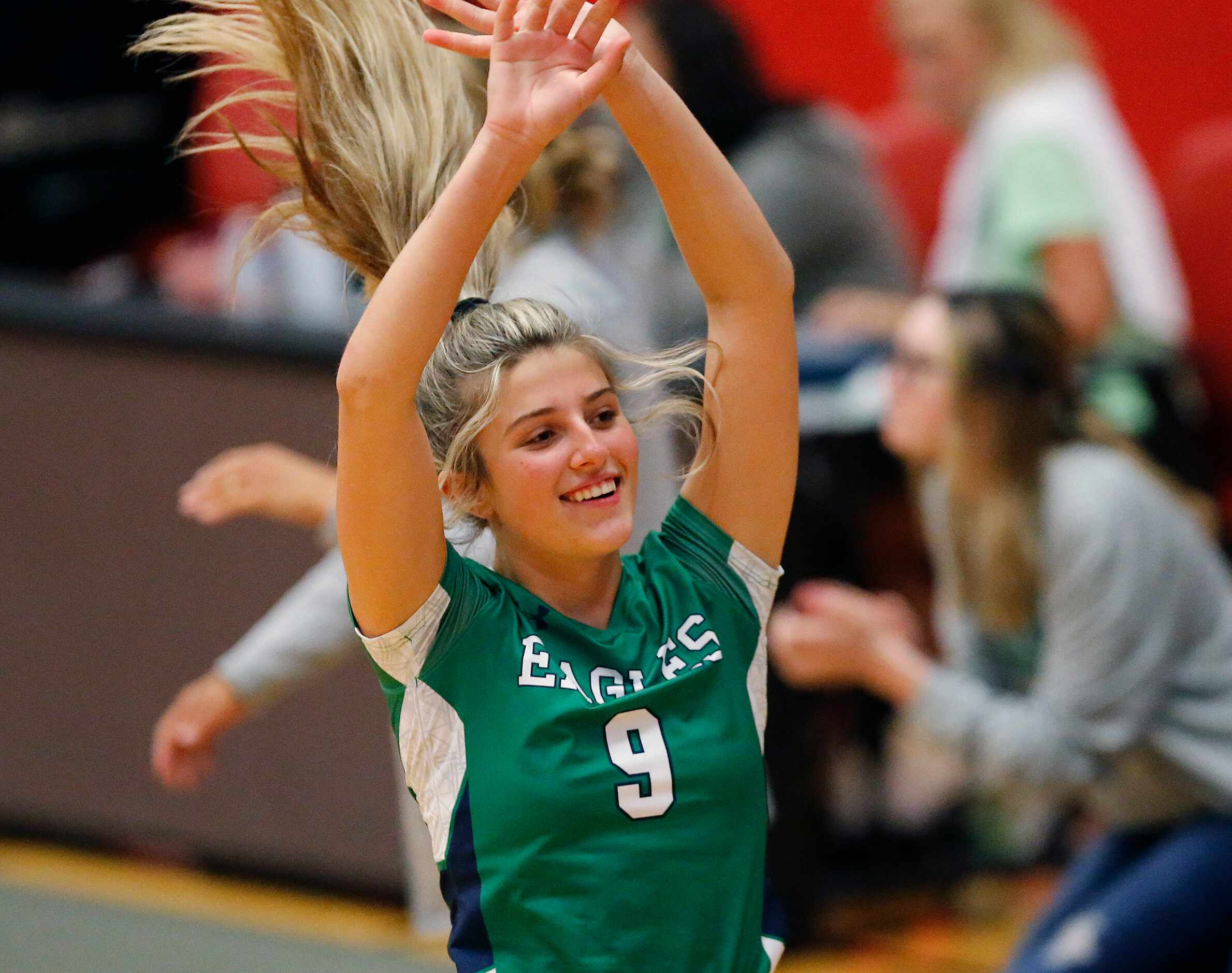 Eaton outside hitter Lily Bickley (9) celebrates a victory in game one as Flower Mound...