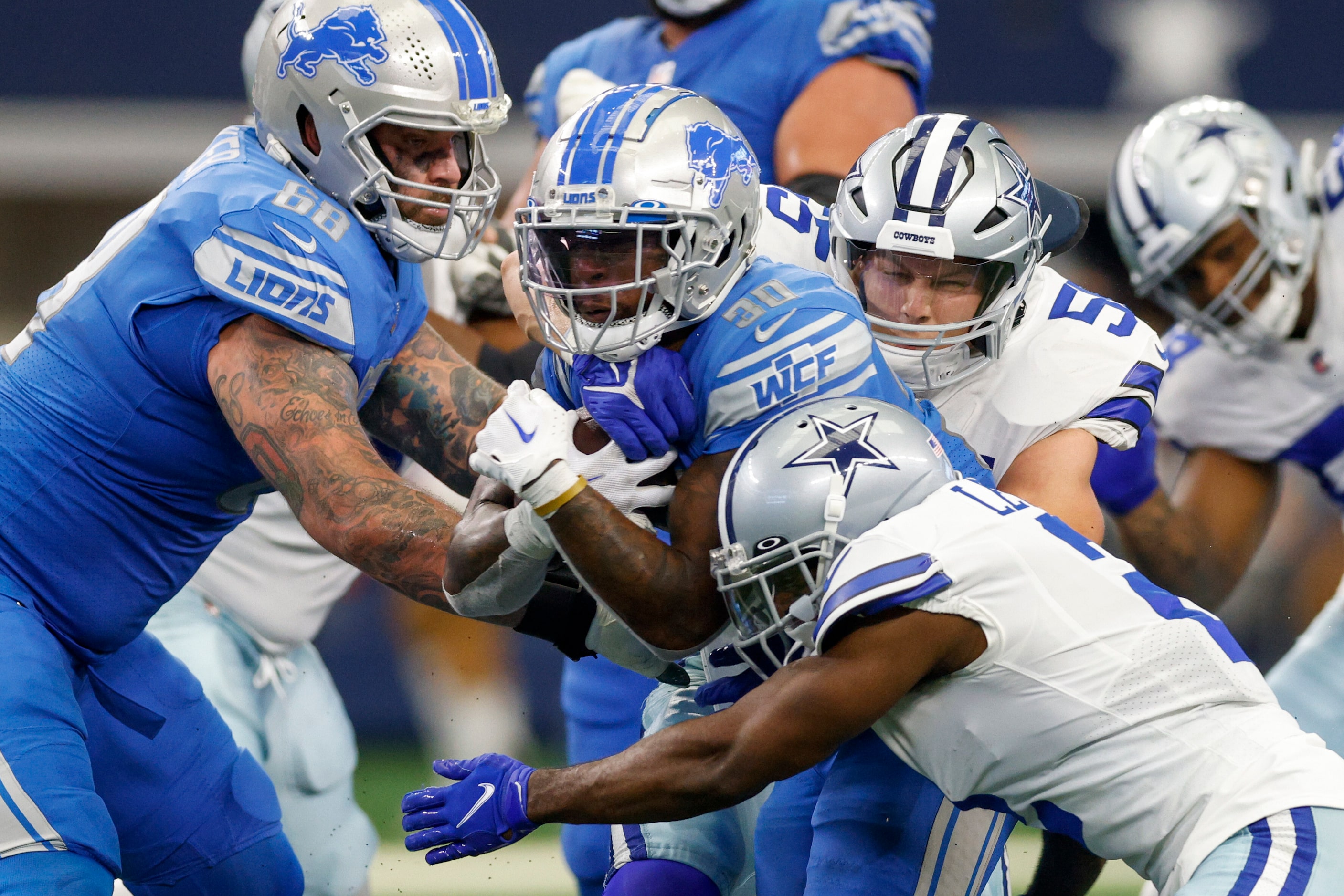 Dallas Cowboys linebacker Leighton Vander Esch (55) and cornerback Jourdan Lewis (2) tackle...