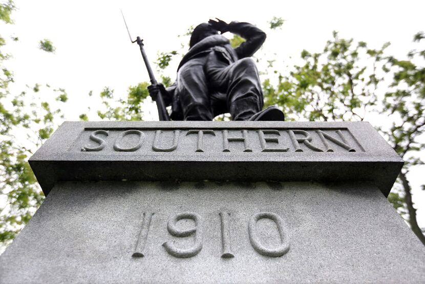 "The Lookout" statue stands guard over the headstones of Confederate soldiers inside the...