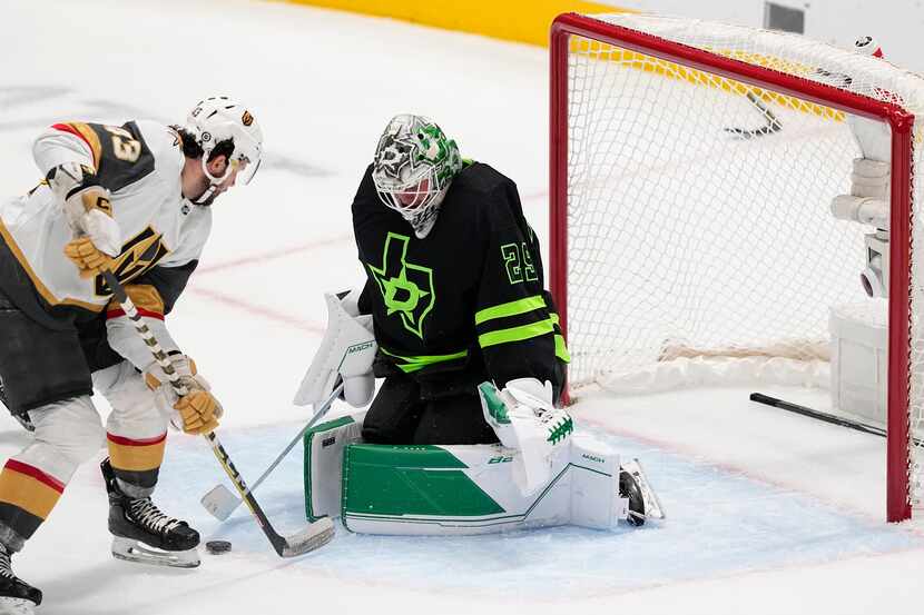 Dallas Stars goaltender Jake Oettinger (29) blocks a shot by Vegas Golden Knights center...