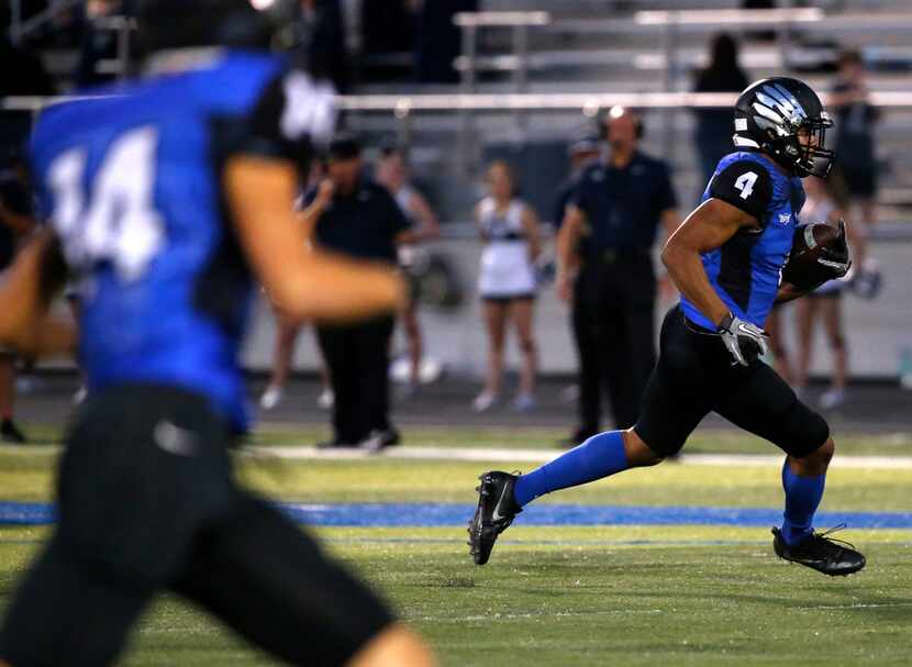 North Forney wide receiver Corey Mayfield (4) runs the ball against Wylie East in the first...