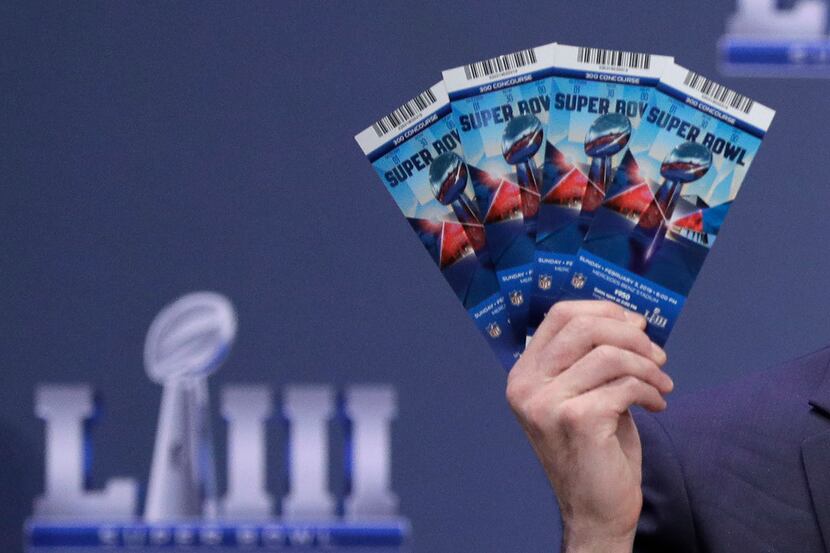 Michael, Buchwald, NFL Senior Counsel, Legal, holds up Super Bowl 53 tickets as he explains...