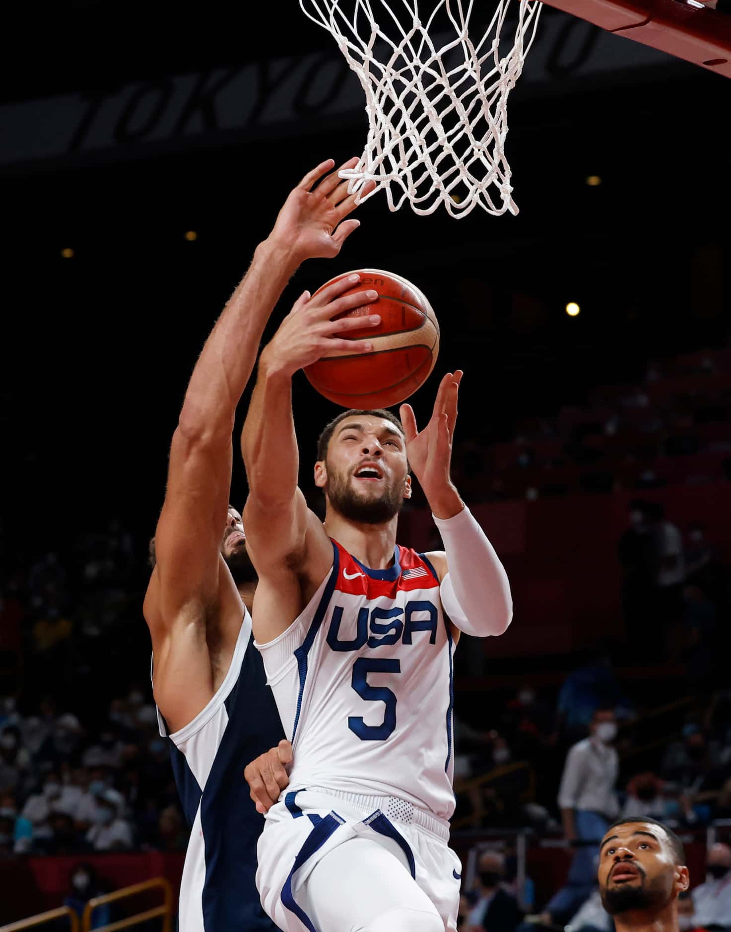 USA’s Zach Lavine (5) is fouled on a shot attempt by France’s Rudy Gobert (27) during the...