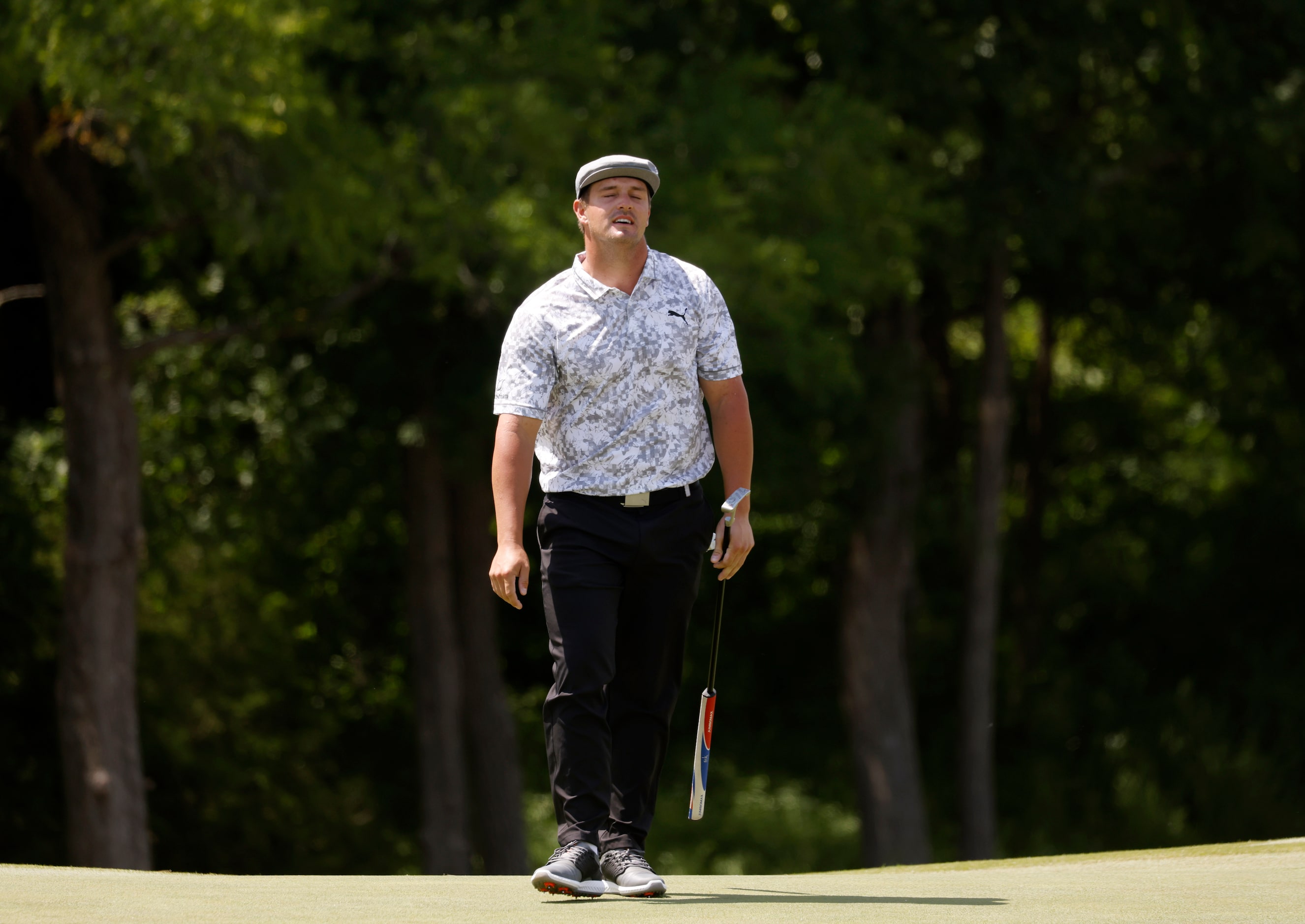 Bryson DeChambeau reacts after missing a putt on the 9th hole during round 2 of the AT&T...