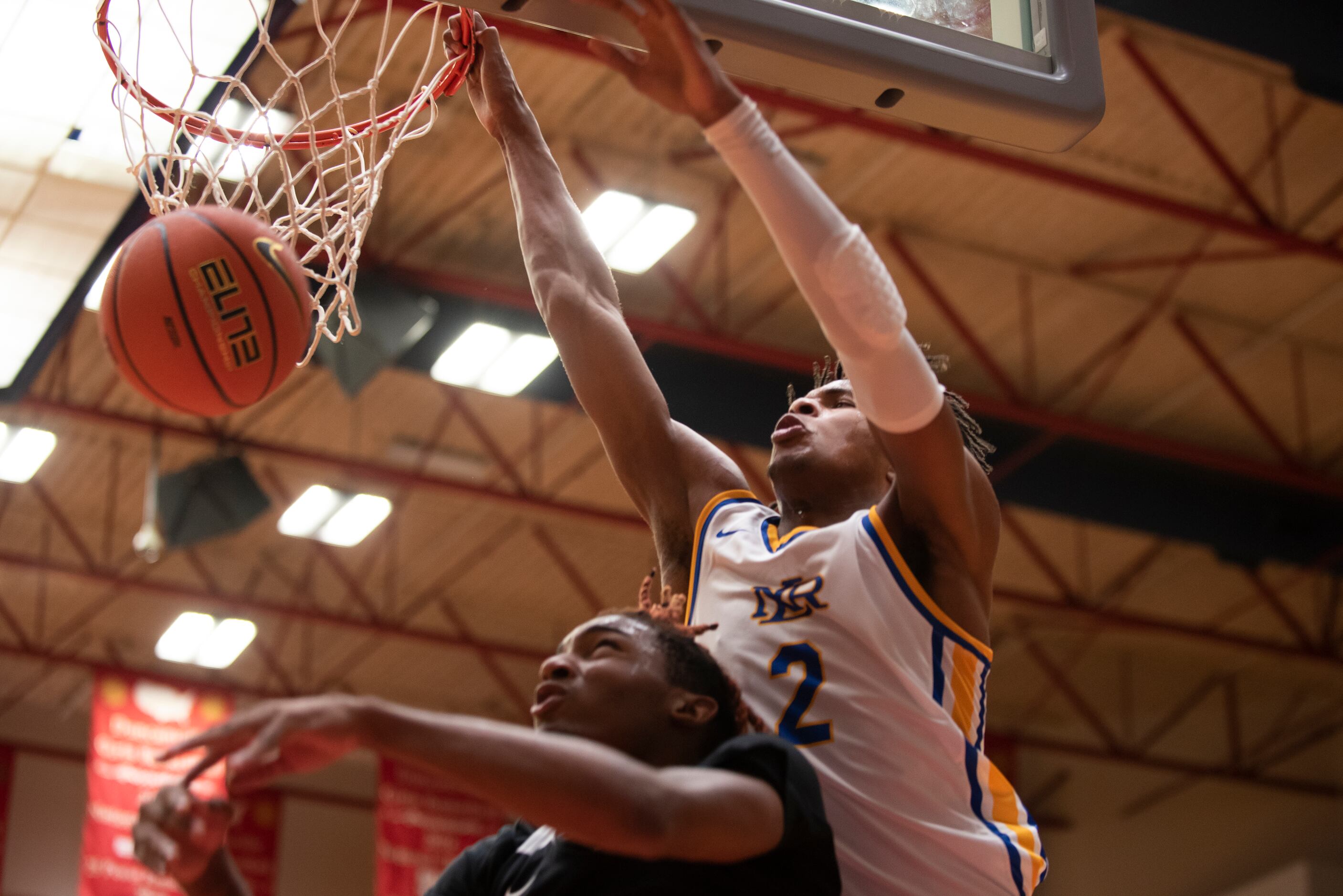 North Little Rock senior Corey Washington (2) scores over Kimball senior Arterio Morris (2)...