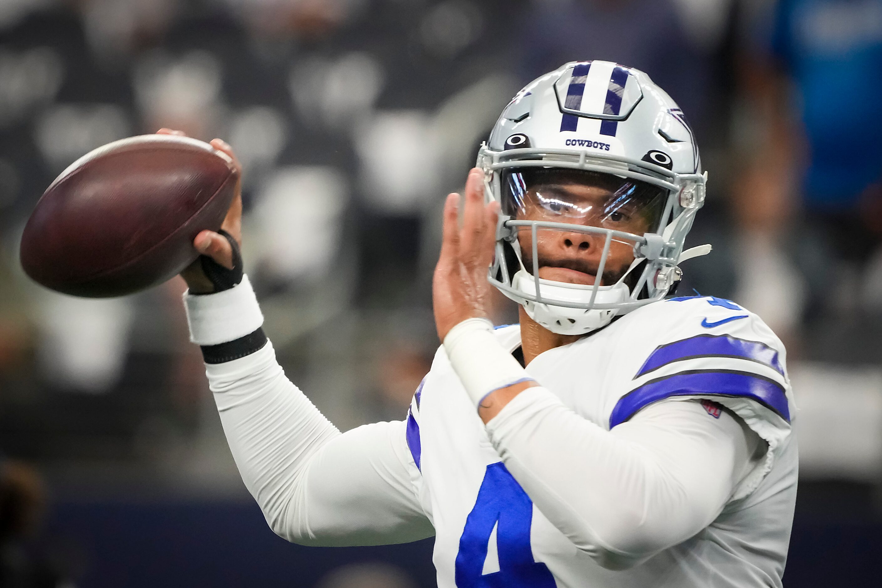 Dallas Cowboys quarterback Dak Prescott warms up before an NFL football game against the...