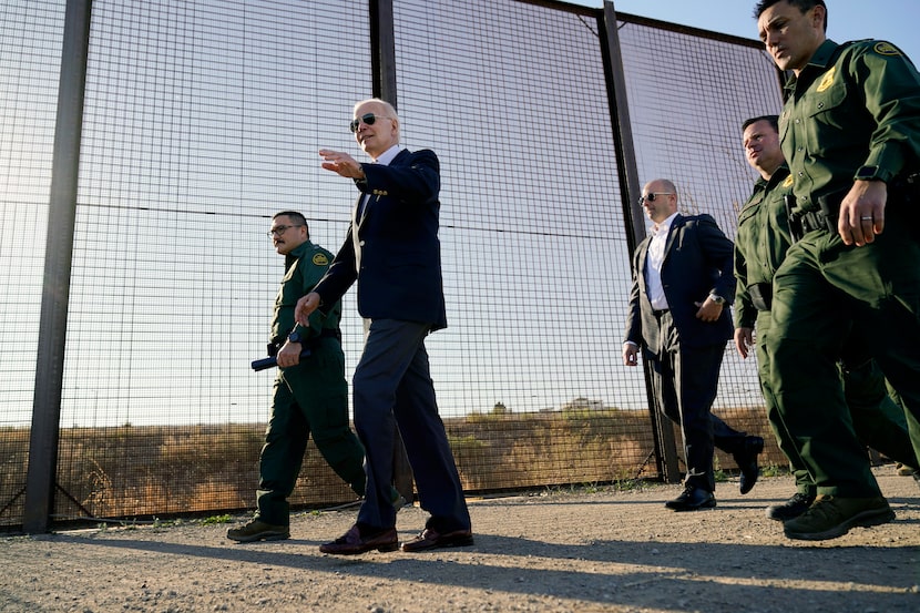 FILE - President Joe Biden walks along a stretch of the U.S.-Mexico border in El Paso Texas,...