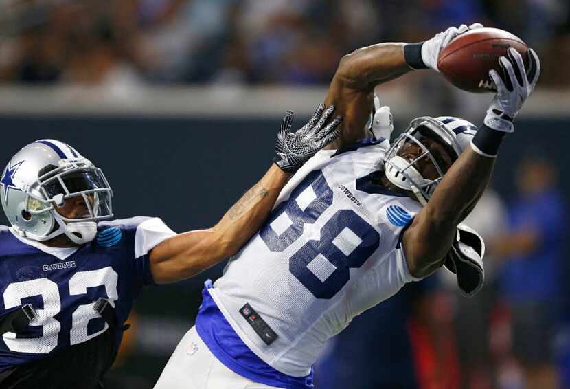Dallas Cowboys wide receiver Dez Bryant (88) grabs a pass in the air as he is defended by...
