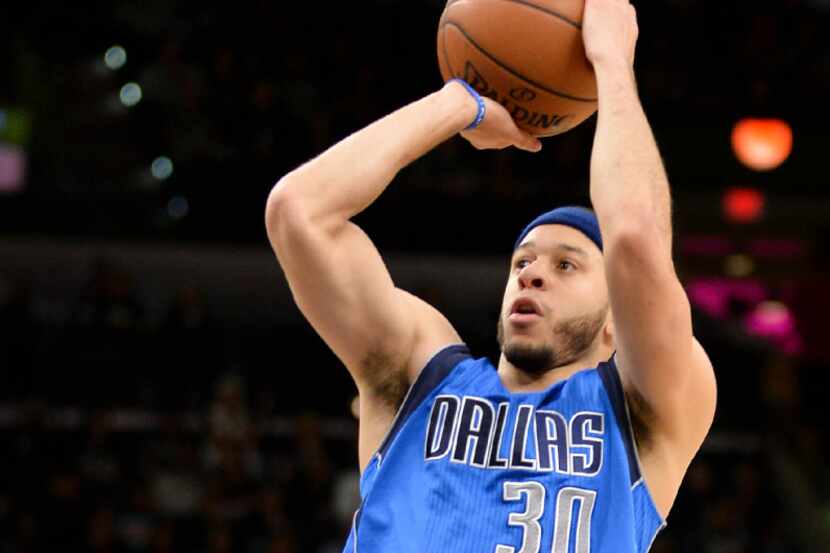 Dallas Mavericks guard Seth Curry shoots during the first half of an NBA basketball game...