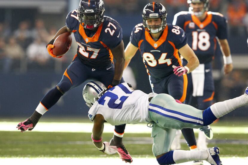 Denver Broncos running back Knowshon Moreno (27) tries to hurdle Dallas Cowboys strong...