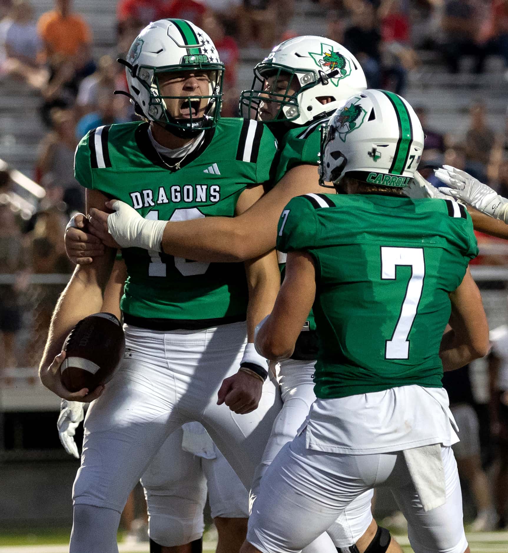 Southlake Carroll quarterback Graham Knowles (10) celebrates a touchdown with his teammates...