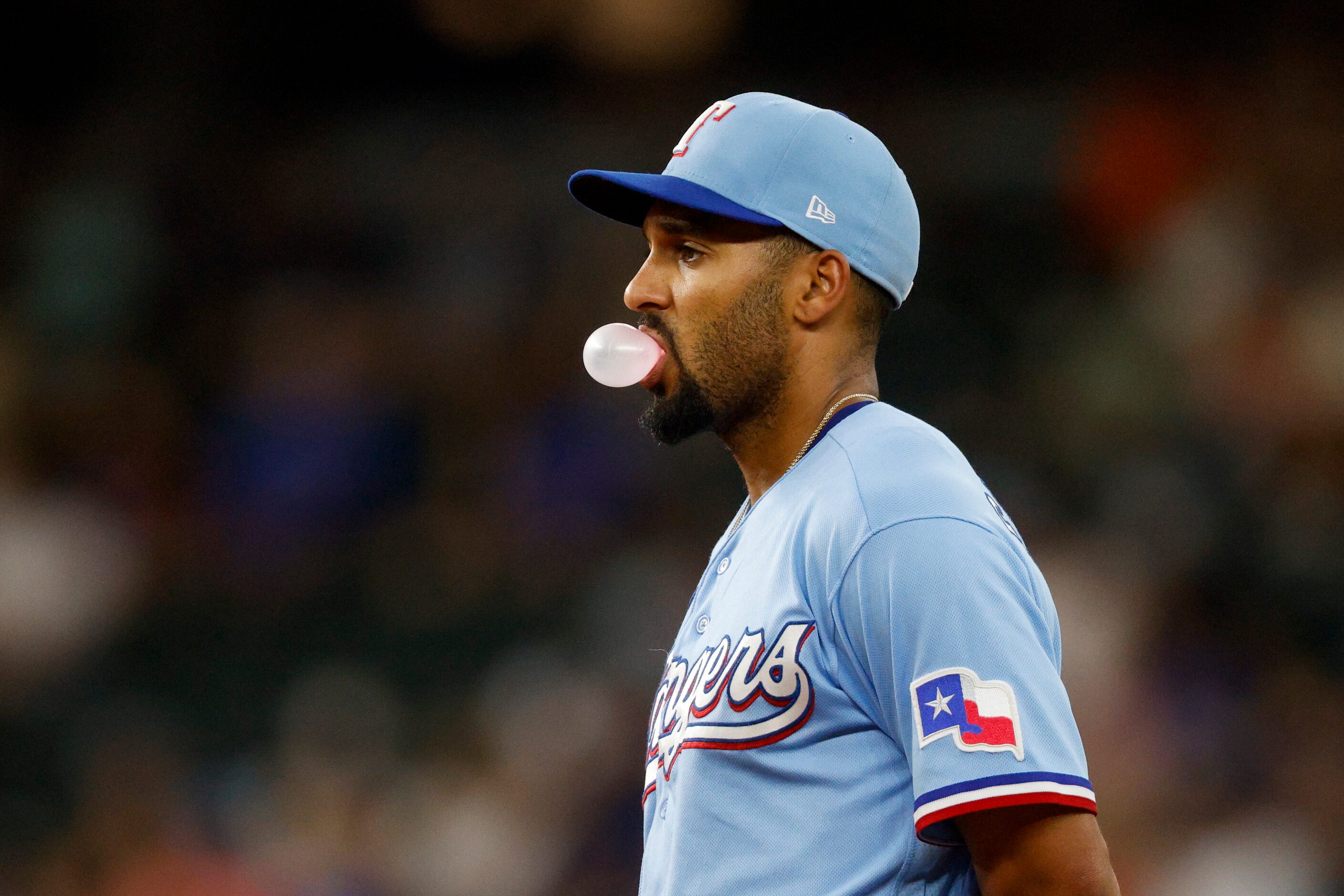 Texas Rangers second baseman Marcus Semien (2) blows a bubble during the seventh inning of a...