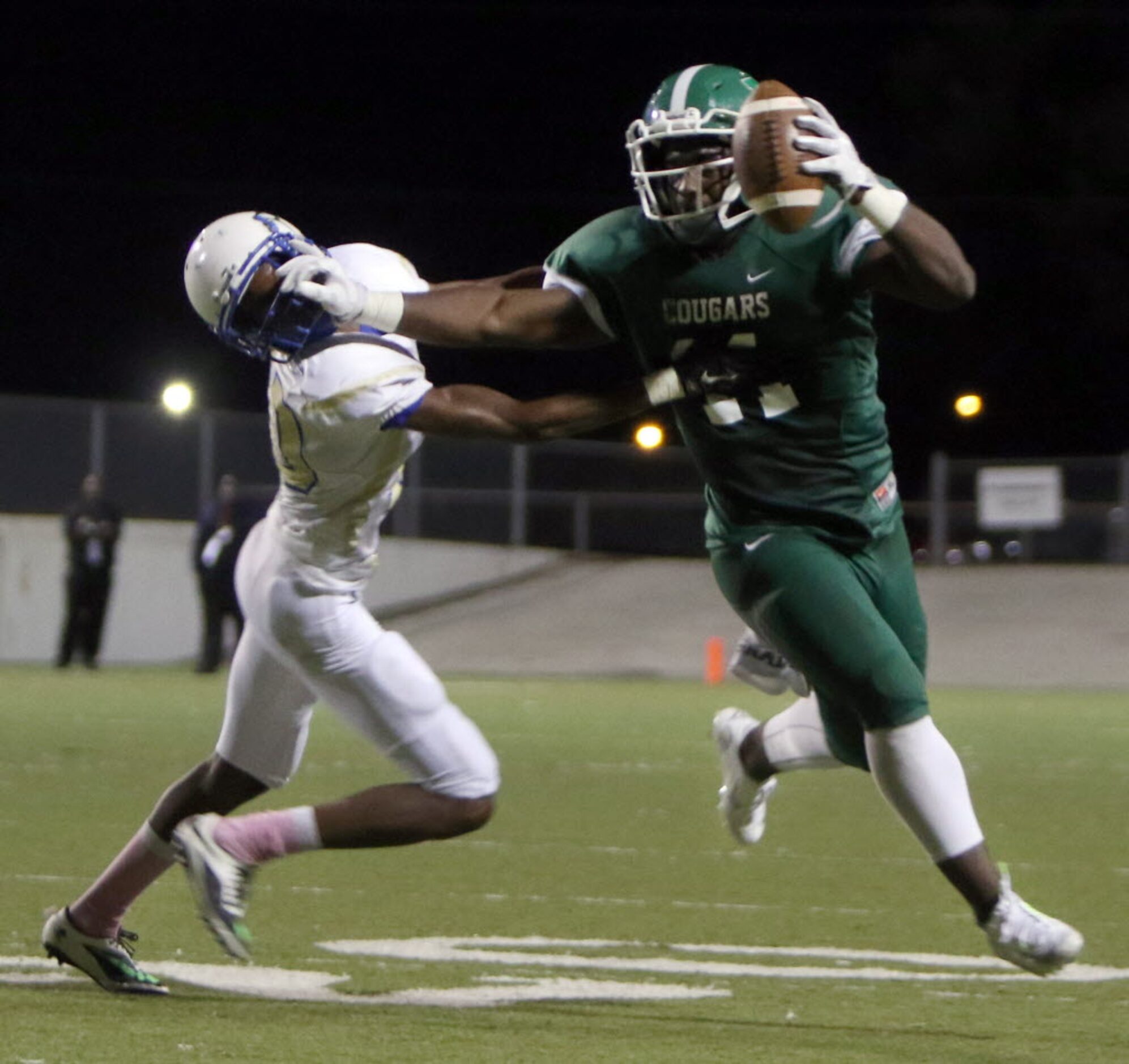 Bryan Adams receiver Keylhin Cheeley (11) powers his way with a stiff-arm to fend off the...