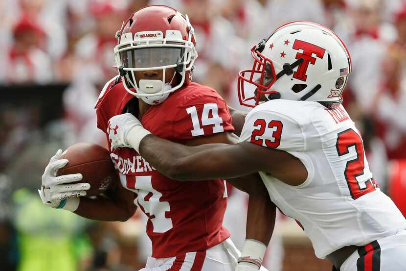 Texas Tech defensive back Damarcus Fields (23) reaches in to tackle Oklahoma wide receiver...
