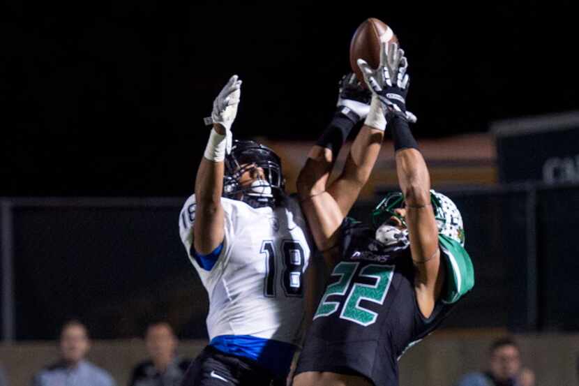 Southlake Carroll senior wide receiver Robert Barnes (22) competes with Trophy Club Byron...