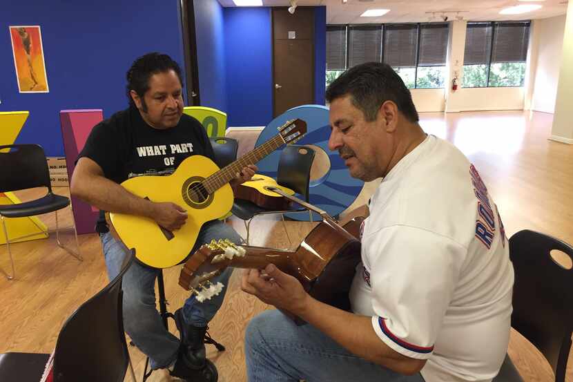 Antonio Salas  (izq.) enseña guitarra a Raul Saldaña, el sábado 8 de junio en el consulado...